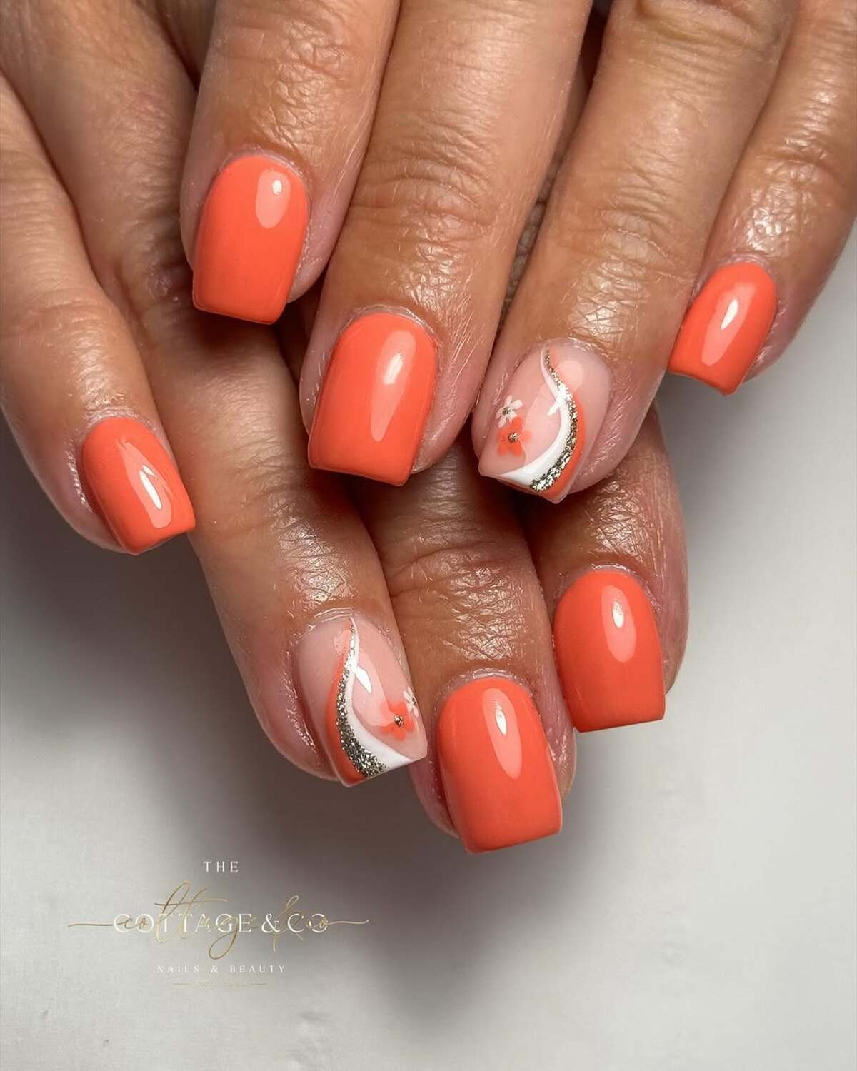 16. Coral Nails with a Sparkling Floral Accent