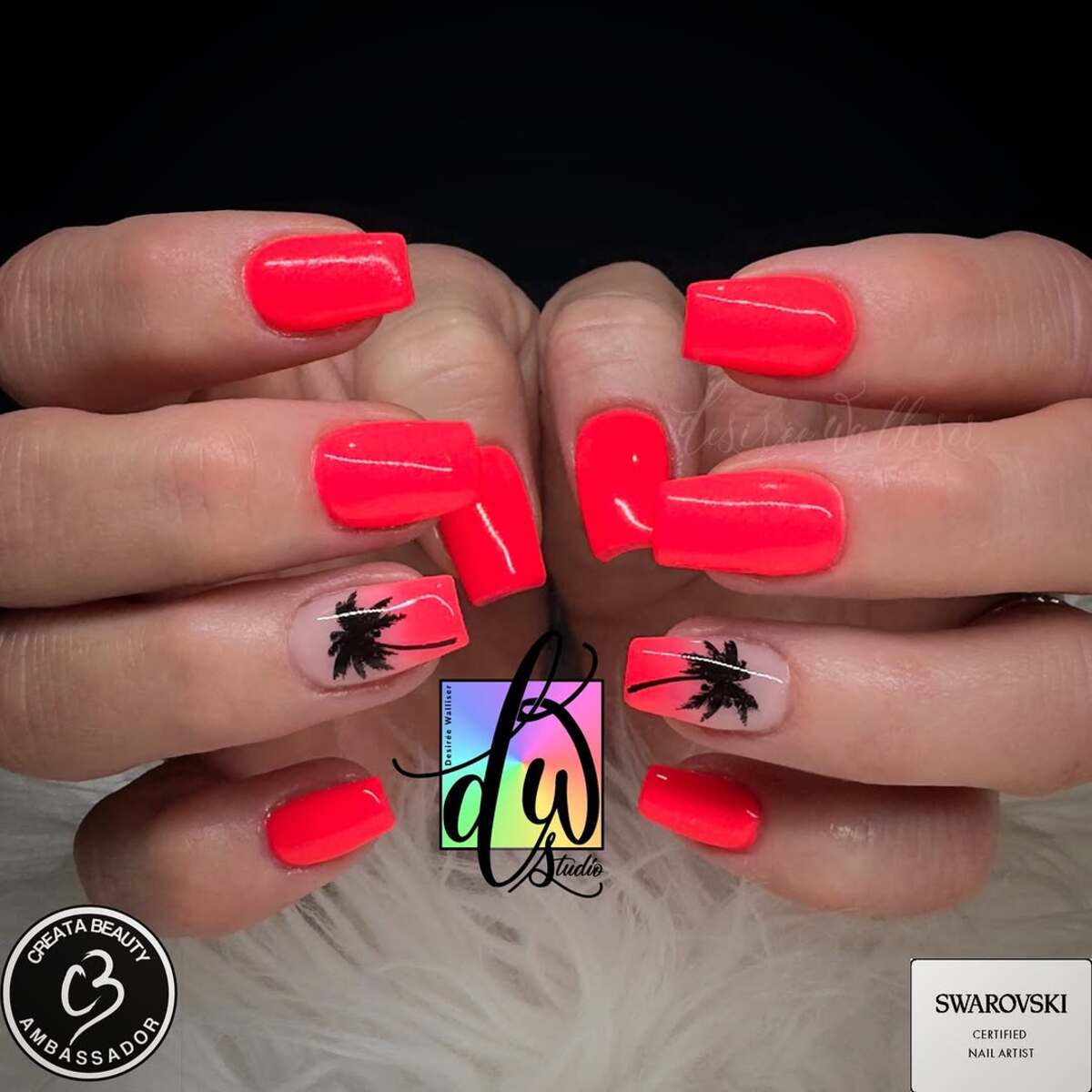 20. Vibrant Neon Coral Nails with Chic Palm Accents