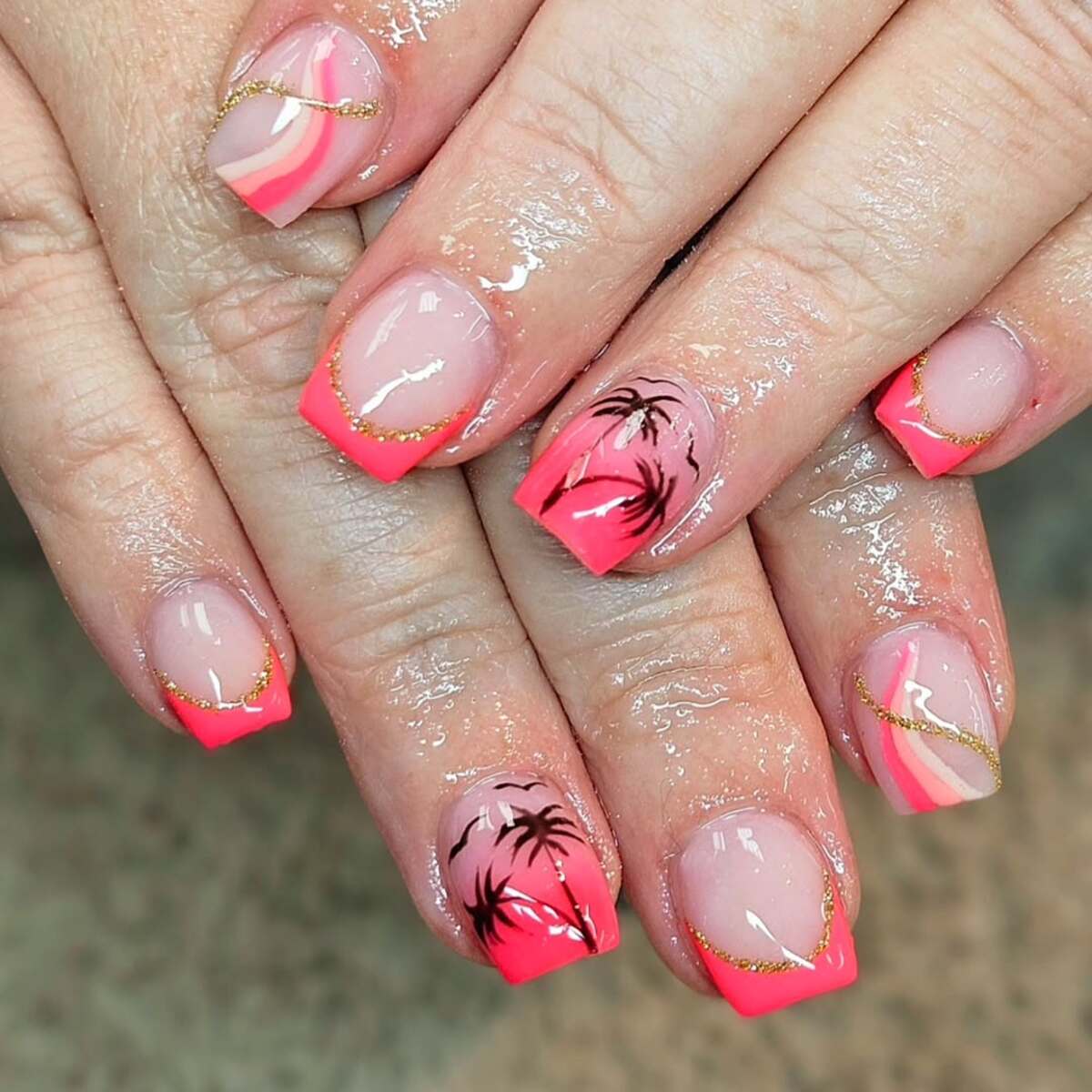 7. Sunset Glow with Coral French Tips and Palm Silhouettes