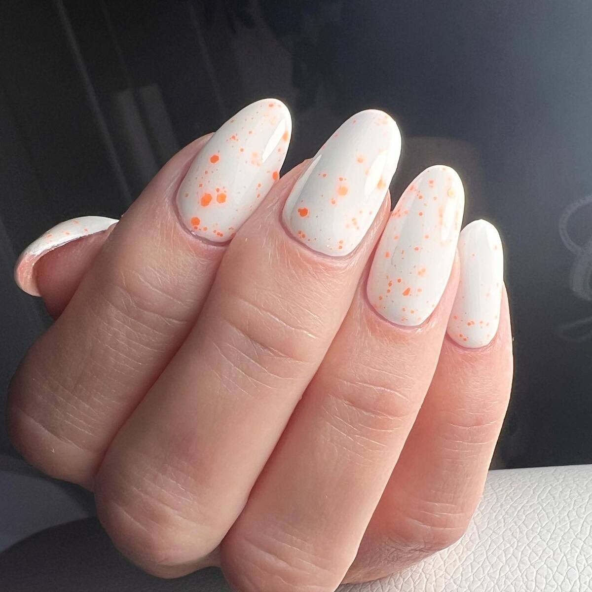 14. White Nails with Orange Speckled Accents