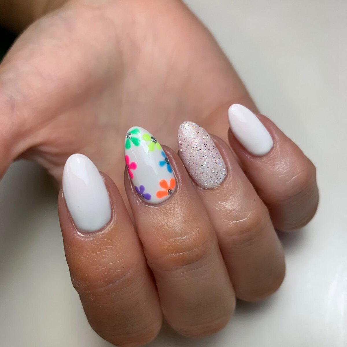 19. White Nails with Colorful Floral Accents