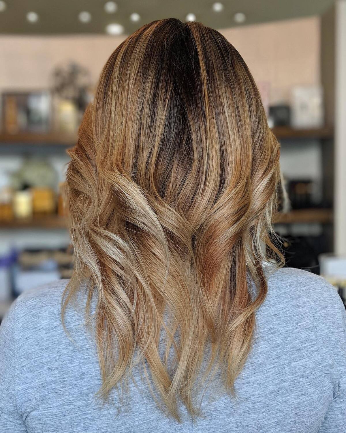 13. Golden Toffee Ombre with Soft Flicked Ends