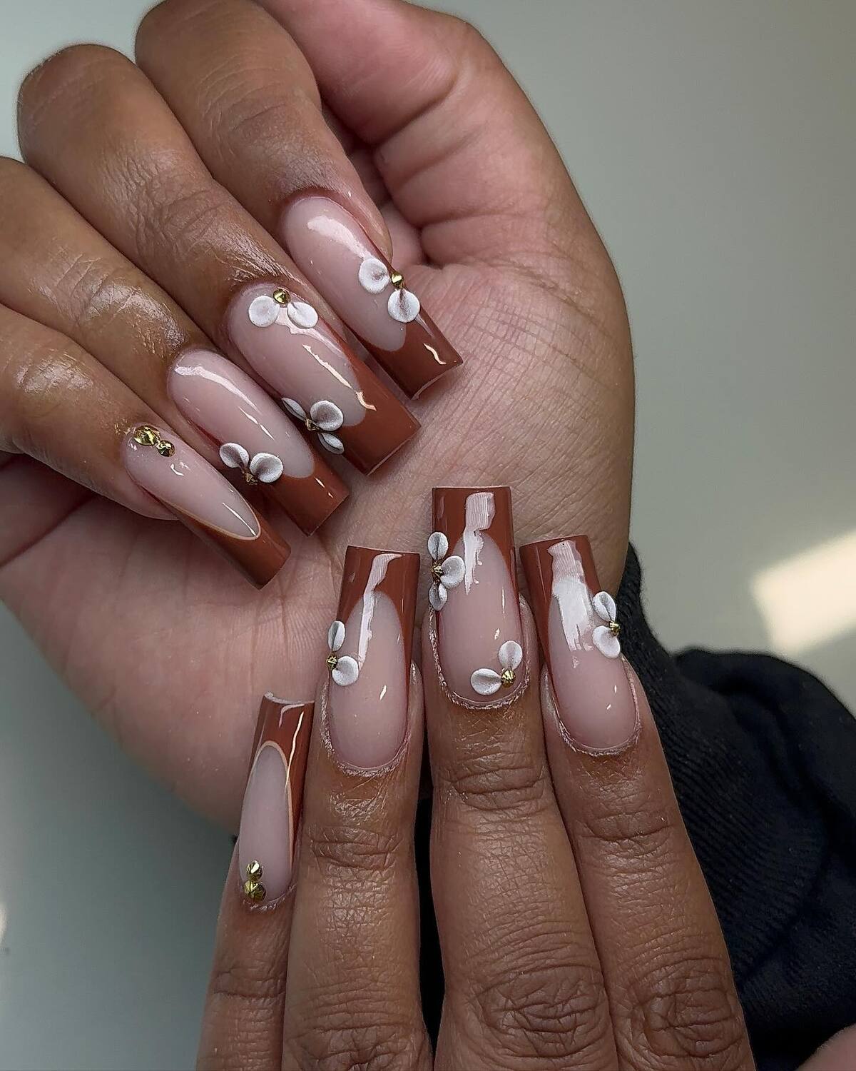 24. Cocoa French Tips with Delicate Daisy Blossoms