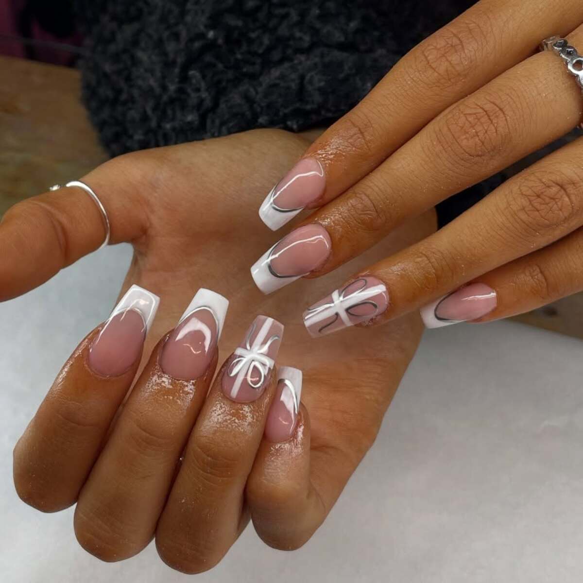 4. Elegant White Gift-Wrapped Nails