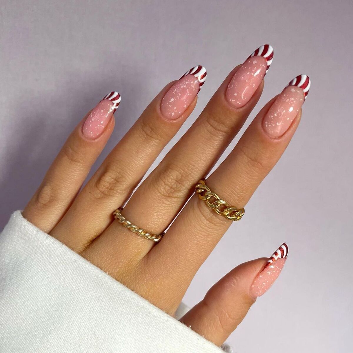 8. Candy Cane French Tips with Snowy Sparkle