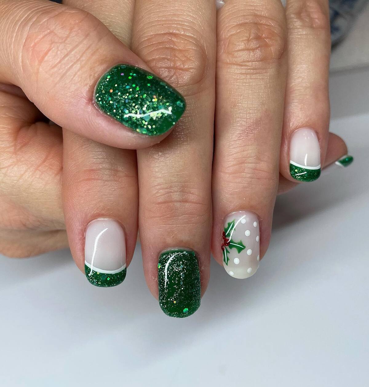15. Holly and Glitter Christmas Nails