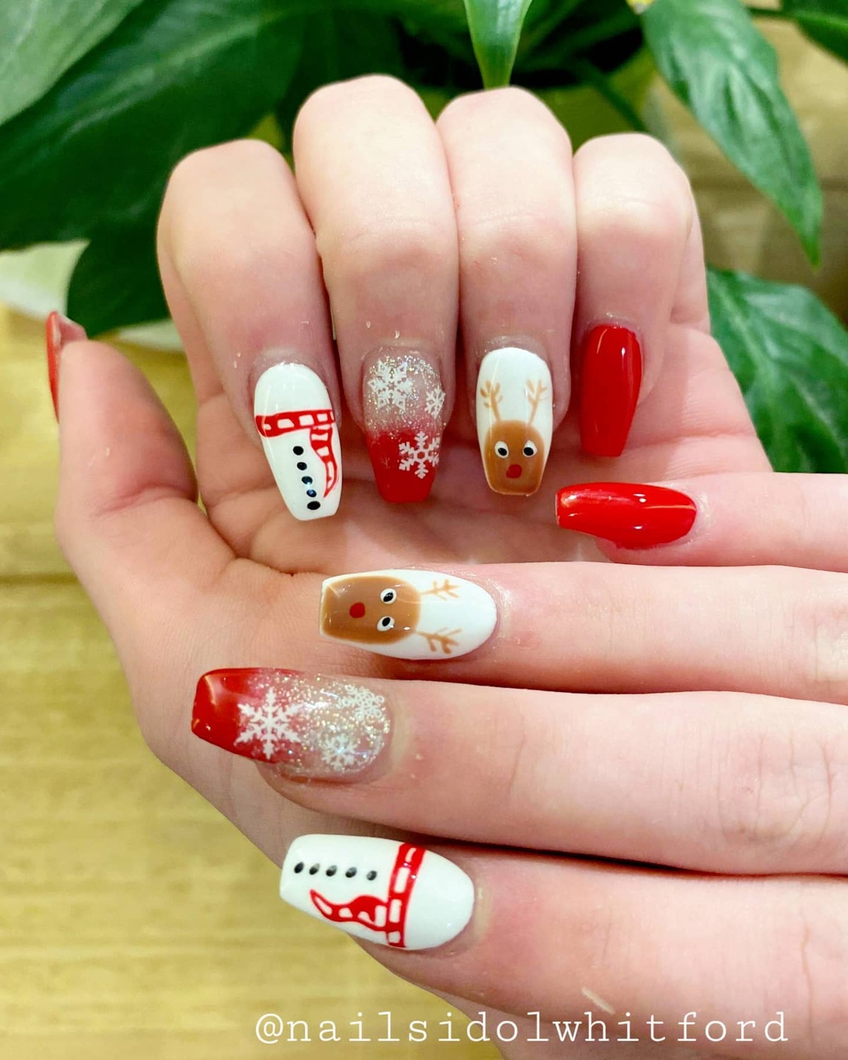 27. Playful Christmas Acrylic Nails with Snowmen and Reindeer