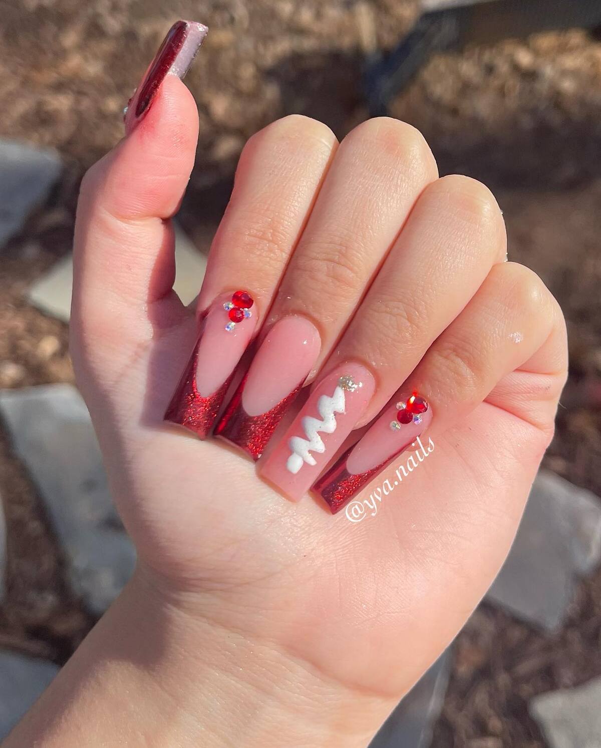 4. Red Glitter Acrylic Nails with Festive Accents