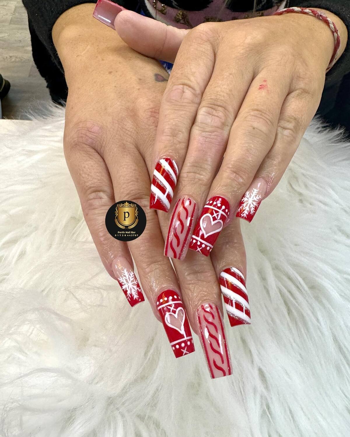 5. Candy Cane Acrylic Nails with Cozy Charm