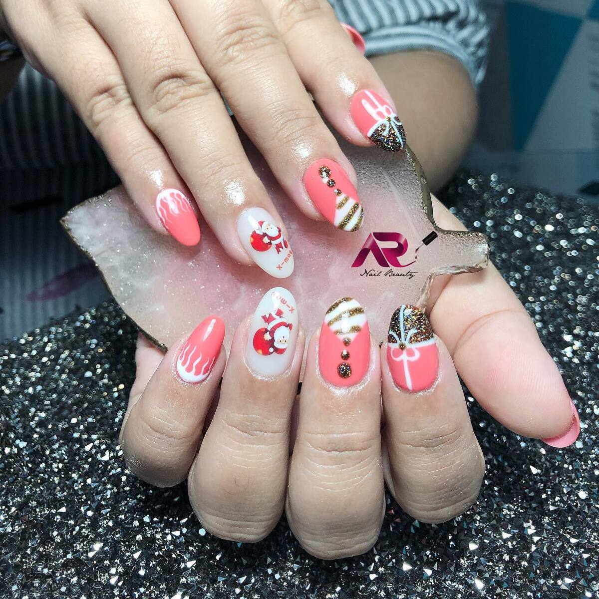 14. Santa and Sparkle Christmas Oval Nails