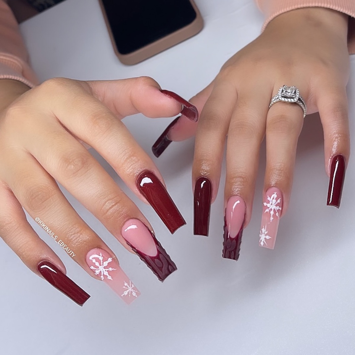 14. Glossy Burgundy Elegance with Snowflake Accents