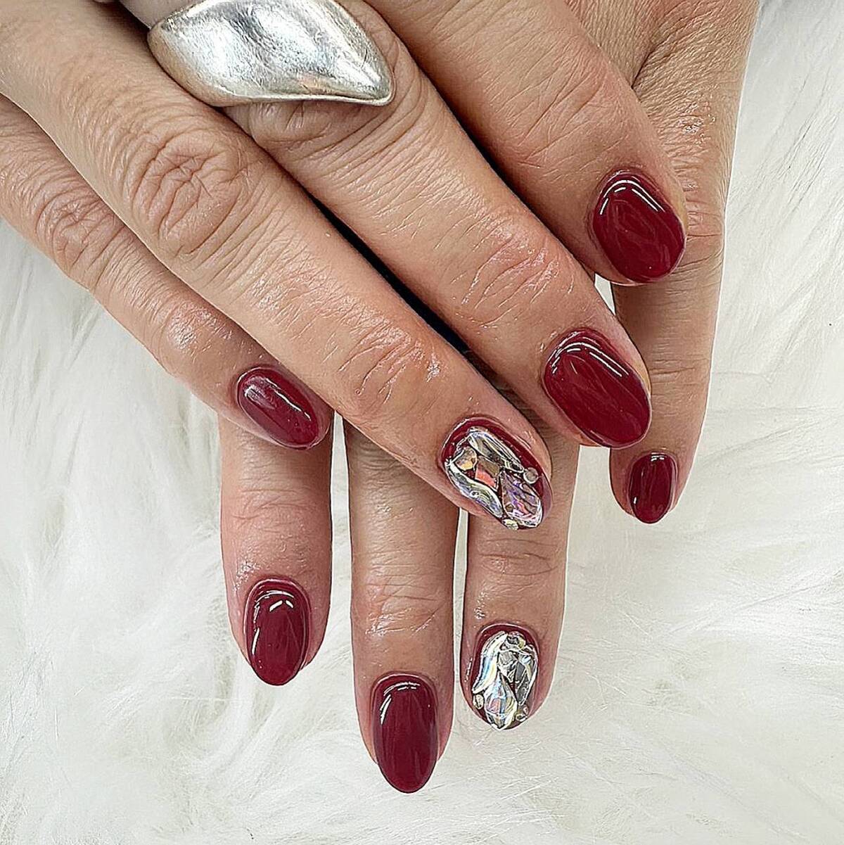 8. Glossy Burgundy Glam with Crystal Accent