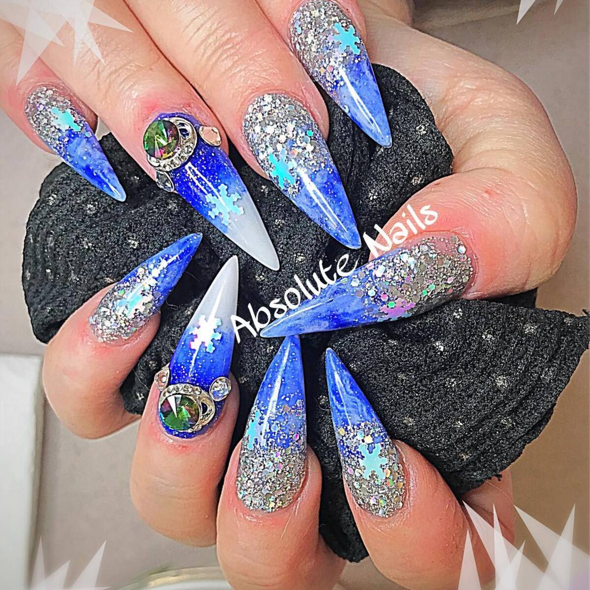 25. Frozen Blue Glitter Nails with Rhinestone Accents